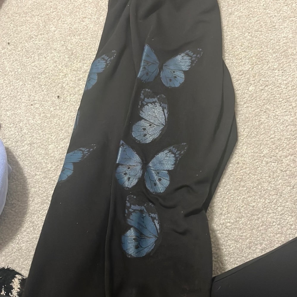 black sweatpants with 4 butterflies on both outsides of the leg